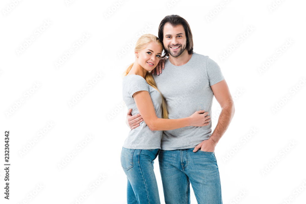 Lovely couple hugging and smiling at camera isolated on white Lovely couple hugging and smiling at camera isolated on white