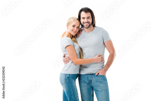 Lovely couple hugging and smiling at camera isolated on white
