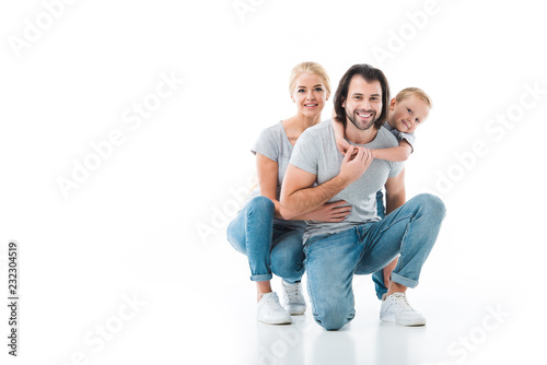 Smiling family hugging together isolated on white