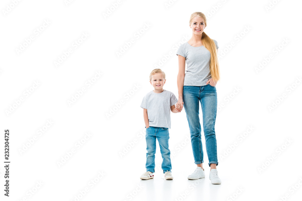 Mom and son holding hands and looking at camera isolated on white Mom and son holding hands and looking at camera isolated on white