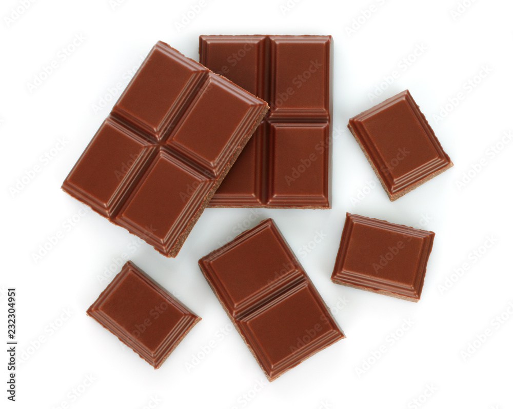 Milk chocolate pieces on white background Milk chocolate pieces on white background