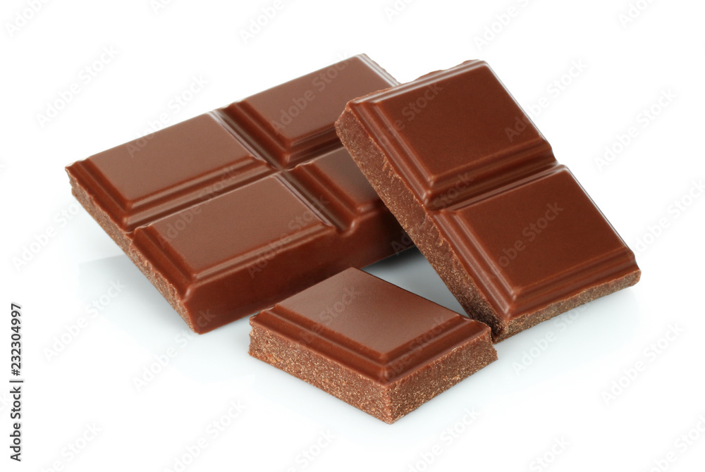 Milk chocolate pieces on white background