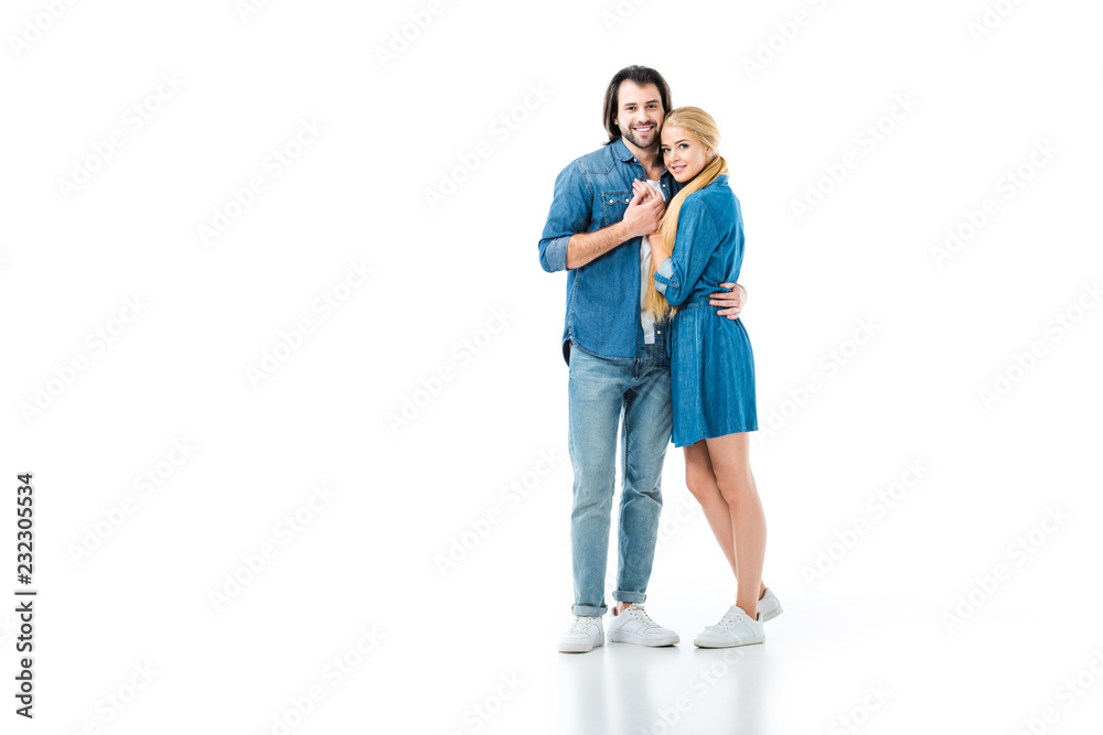 Girl in denim dress and man in jeans and denim shirt hugging each other isolated on white Girl in denim dress and man in jeans and denim shirt hugging each other isolated on white