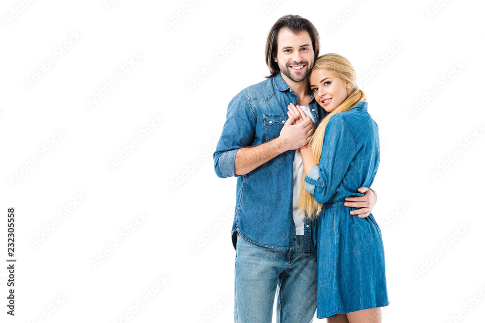 Lovely couple in jeans holding hands and hugging isolated on white Lovely couple in jeans holding hands and hugging isolated on white