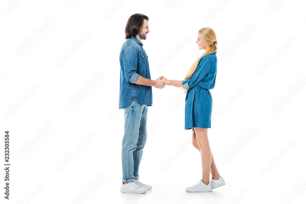 Man and woman holding hands and looking at each other isolated on white