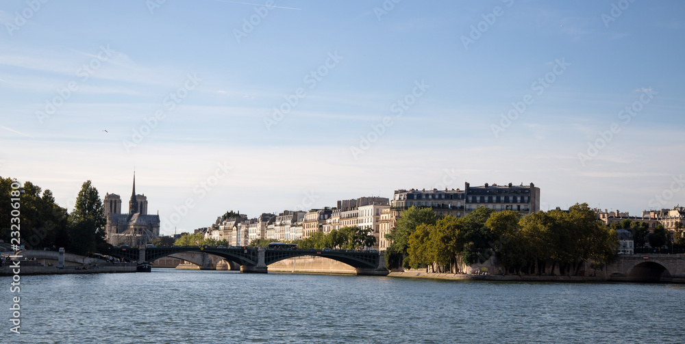 Fototapeta premium PARIS, FRANCE, SEPTEMBER 8, 2018 - Isle de la Cite with Notre Dame Church seen from the boat from Seine River of Paris, France.