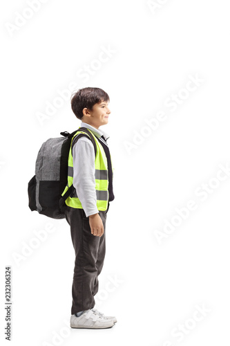 Little schoolboy with a safety vest standing