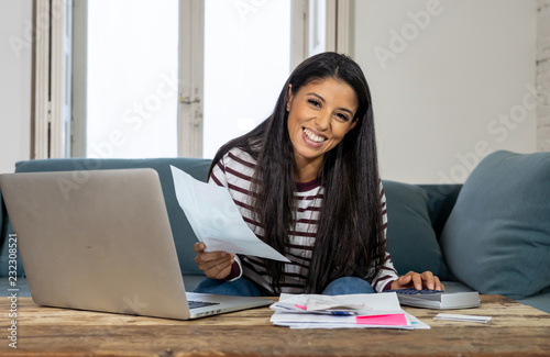Cheerful beautiful woman paying bills online and managing budget feeling happy and relax © SB Arts Media