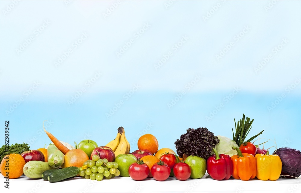 Colorful ripe vegetables and fruits on background