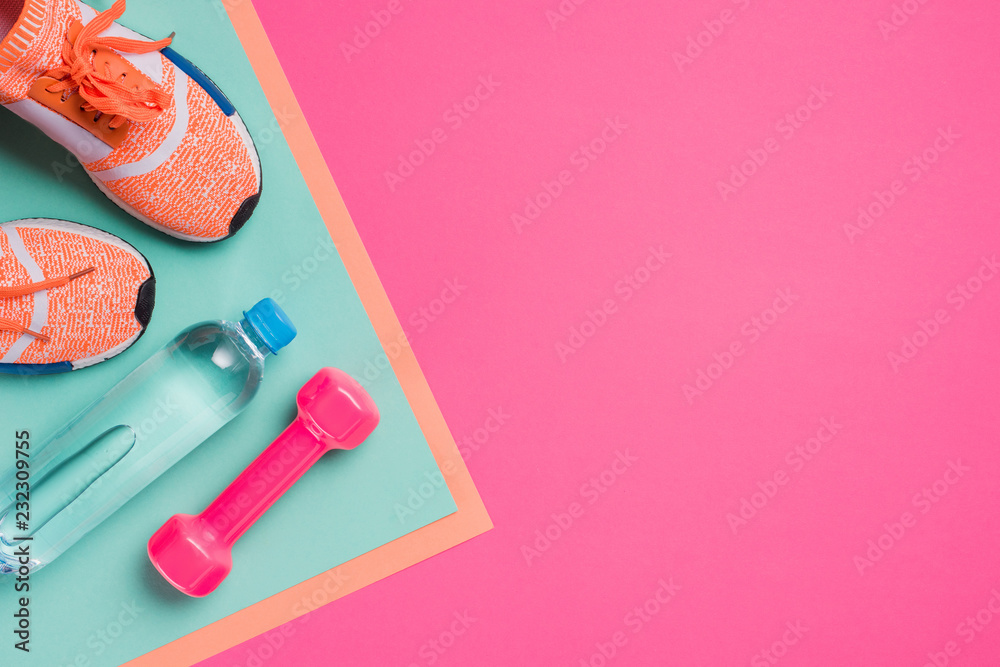 Flat lay with sport equipment on pink background
