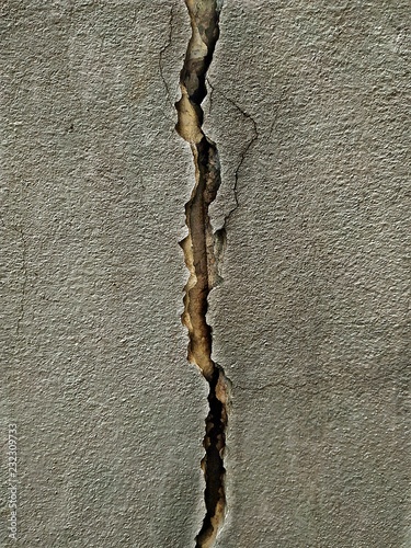 Old cracked wall. broken black cement and dirty hiatus background