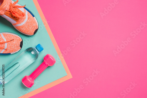 Fotografia Flat lay with sport equipment on pink background
