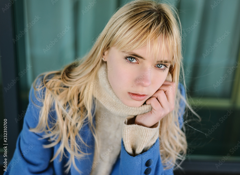 Portrait of young woman wearing blue coat. Portrait of young woman wearing blue coat.
