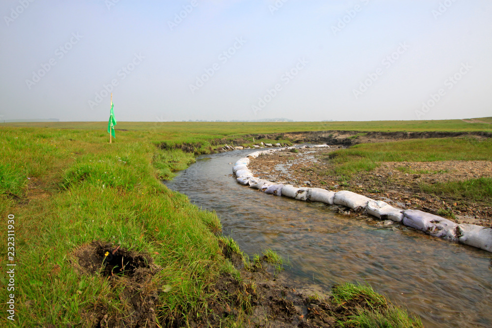 Fototapeta premium small river in the WuLanBuTong grassland, China
