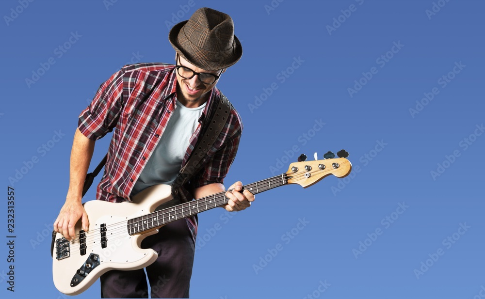 Obraz premium Man playing guitar on light background