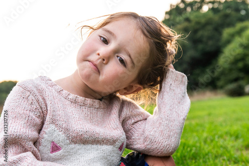 Child sitting on grass in park