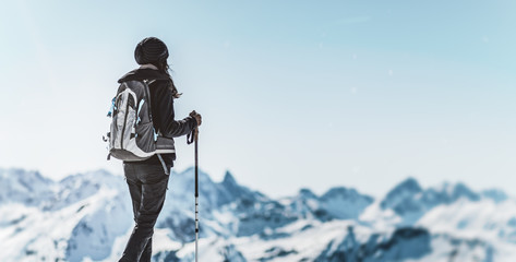 Athletic woman trekking in a winter landscape