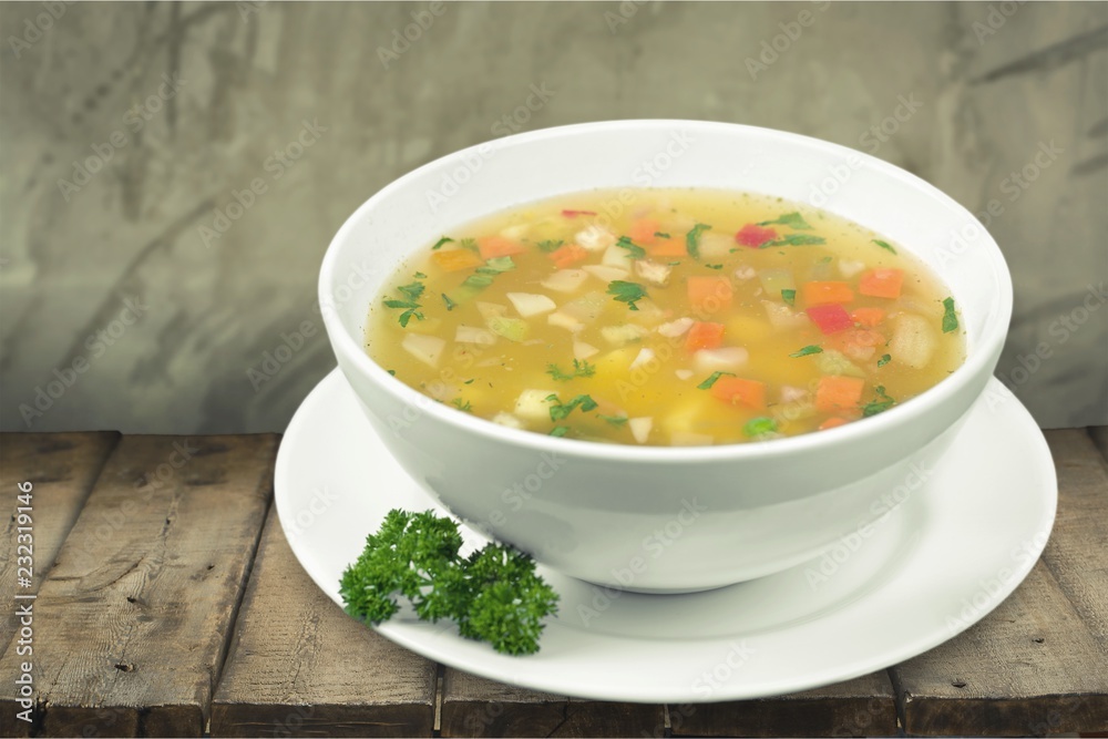 Bowl of delicious soup on wooden table Bowl of delicious soup on wooden table