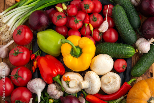 Vegetables and nuts on a brown wooden background