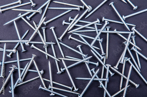 some screws  bolts on a dark background