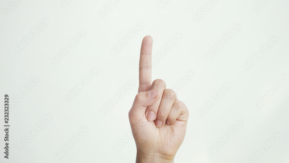 Close up of isolated female hand shows index finger up isolated on white background