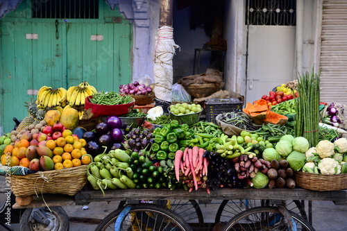 Indian street vendor with fresh vegetables and fruits along the road, Udaipur, India