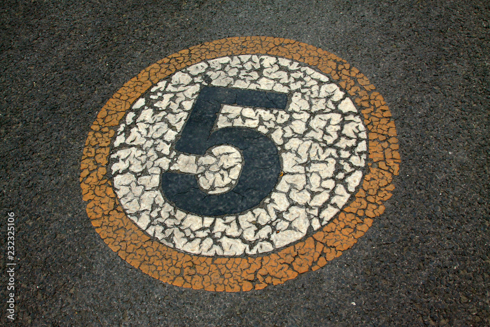 Numbers signs on the asphalt road