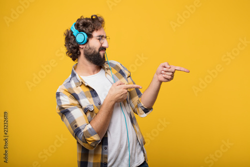 young crazy mad man fool pose listening music with a headphones