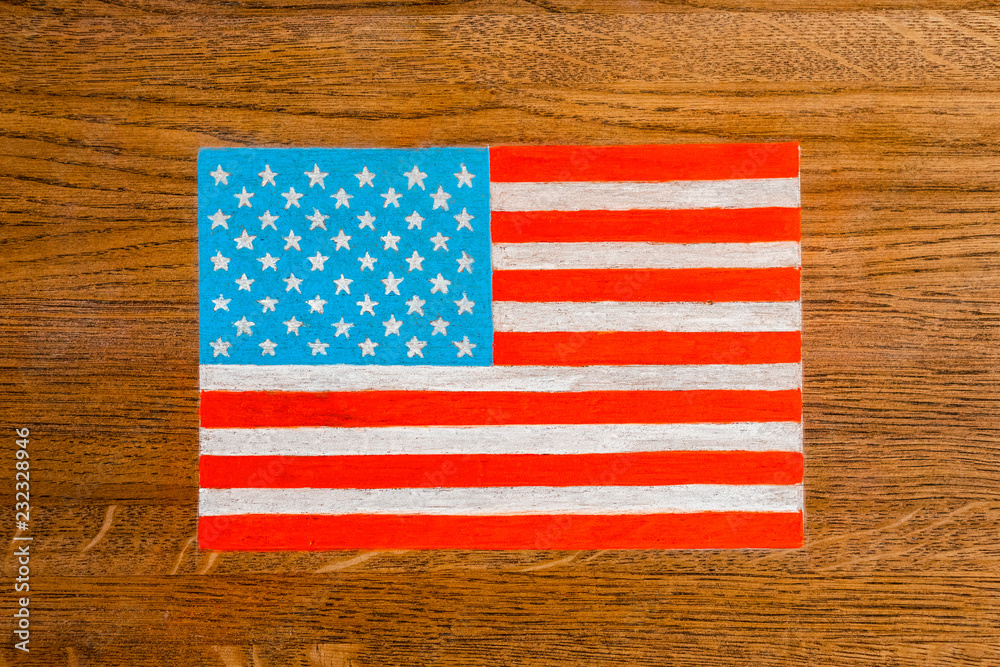 Figure of the US flag on the background of a wooden surface coating. background Figure of the US flag on the background of a wooden surface coating. background
