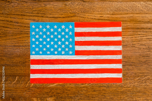 Figure of the US flag on the background of a wooden surface coating. background