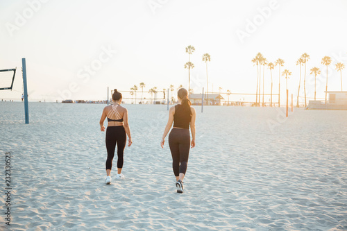 Friends walking on beach, Long Beach, California, US