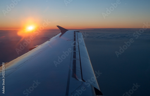 Aircraft jet wing with sunset