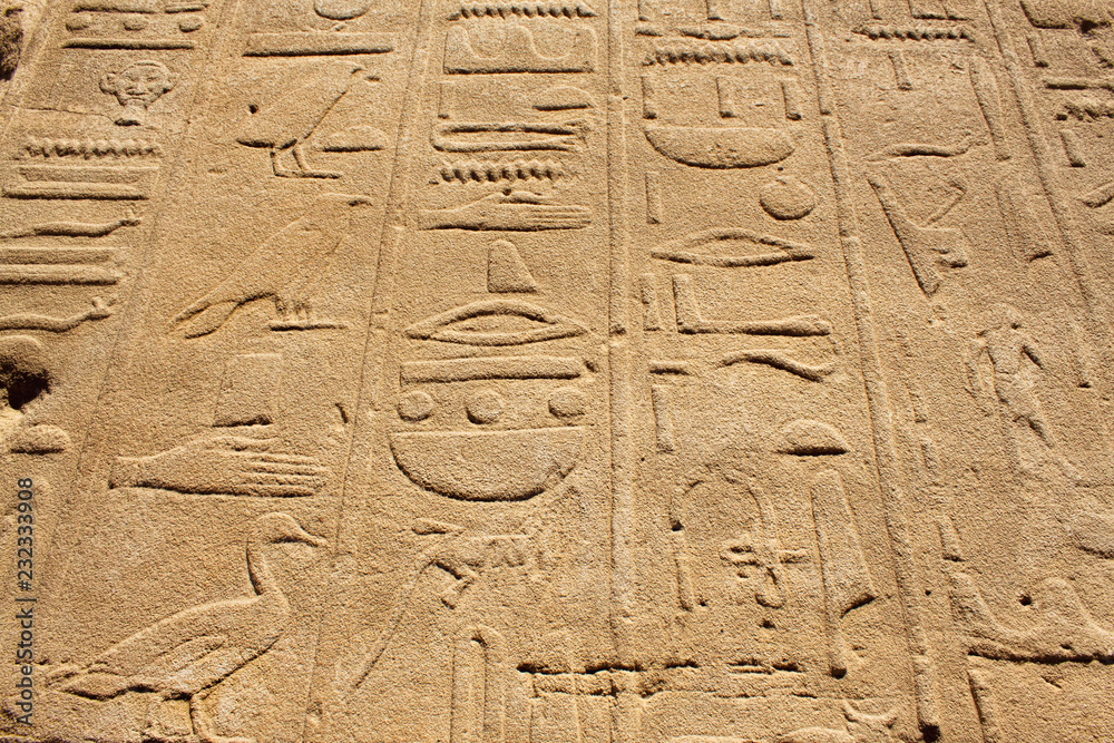 Ancient stone wall with Egyptian hieroglyphs