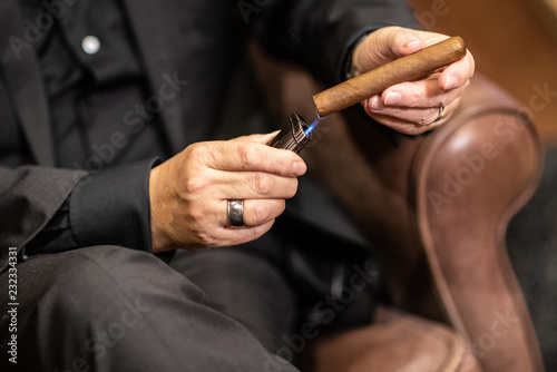 man lighting a cigar photo