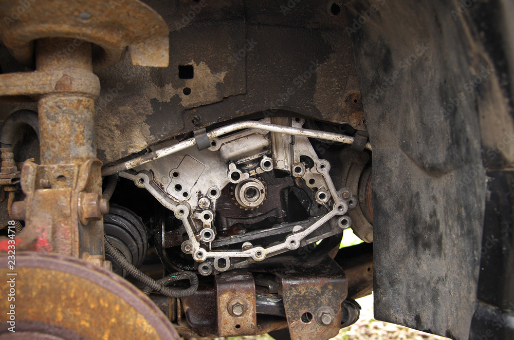 engine, absorber and rusty brake disc on a broken car in the yard