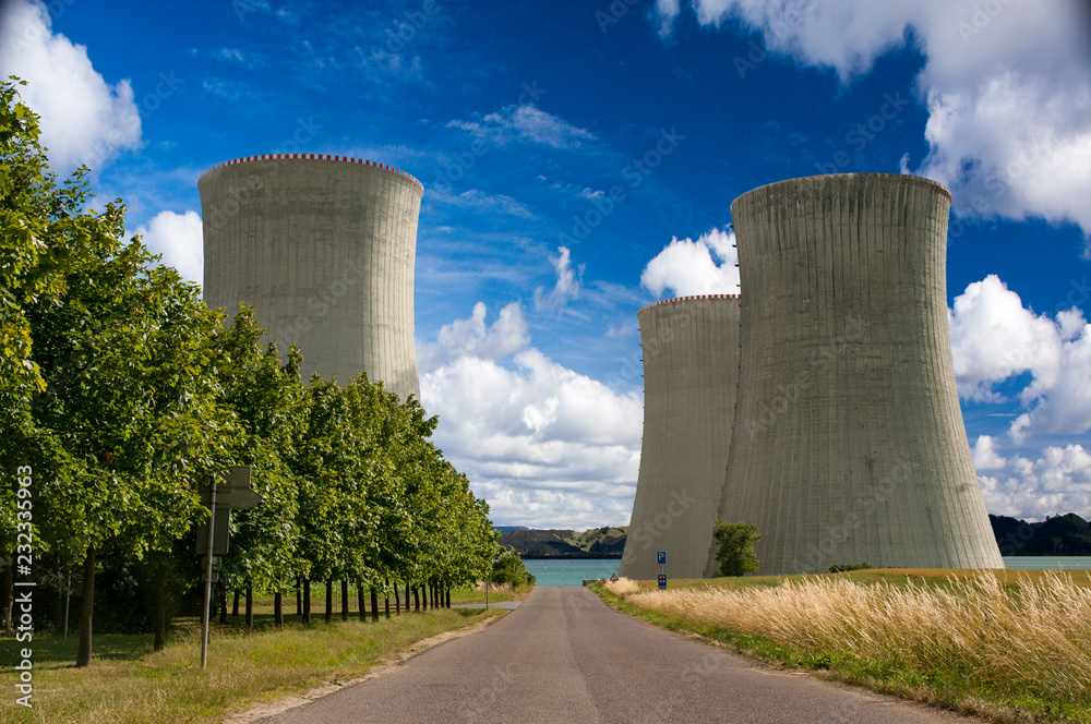 Atomic power plant with lake behind and blue sky. Atomic power plant with lake behind and blue sky.