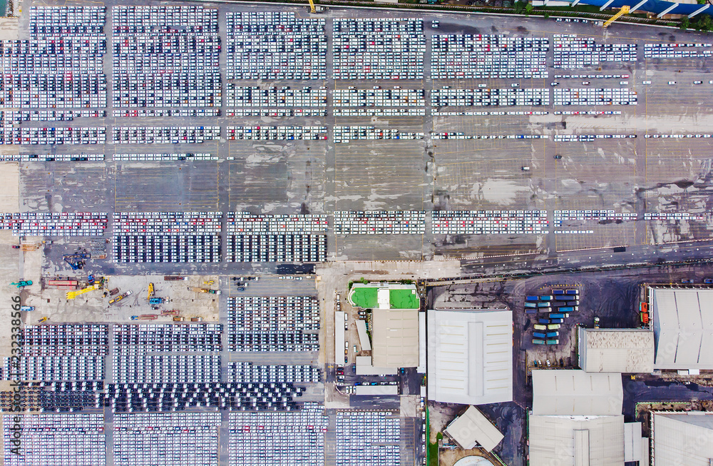 Transportation aerial view from drone top view new cars lined up in the port for import and export.Stock waiting for export Transportation aerial view from drone top view new cars lined up in the port for import and export.Stock waiting for export