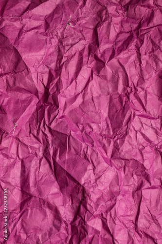 Purple crumpled sheet of paper. Vertical background.