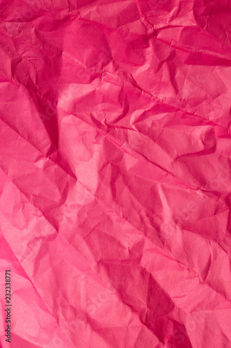 Crumpled red sheet of paper. Vertical background.