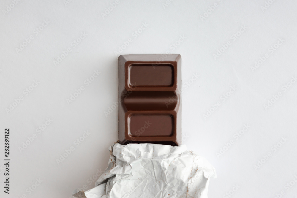 Obraz premium Chocolate bar on a light background.