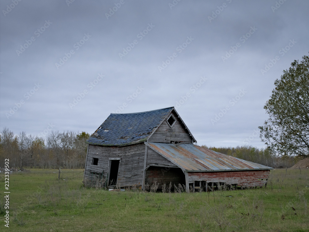 Dreary Abandoned Dilapidated Farm Shed with cloud skies in northern Minnesota Dreary Abandoned Dilapidated Farm Shed with cloud skies in northern Minnesota