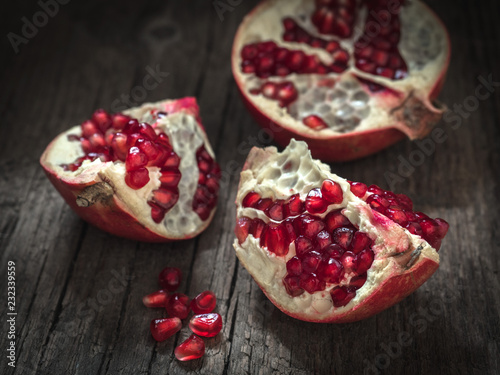 Ripe red fresh pomegranate fruit on wooden rustic background. Healthy food, closeup, flat lay, top view
