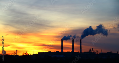 chimney emission on background a sunny dawn