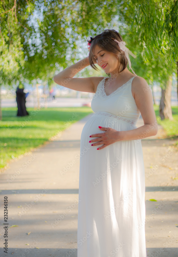 Beatiful Pregnant women smiling during the sunset Beatiful Pregnant women smiling during the sunset