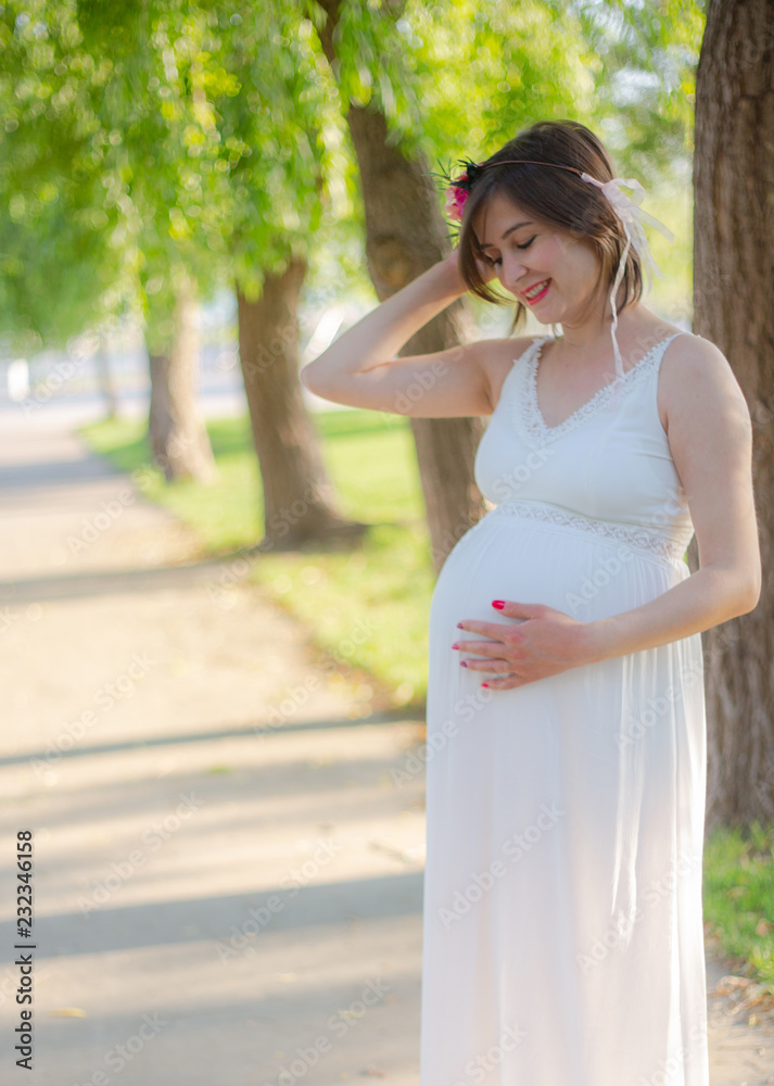 Beatiful Pregnant women smiling during the sunset Beatiful Pregnant women smiling during the sunset