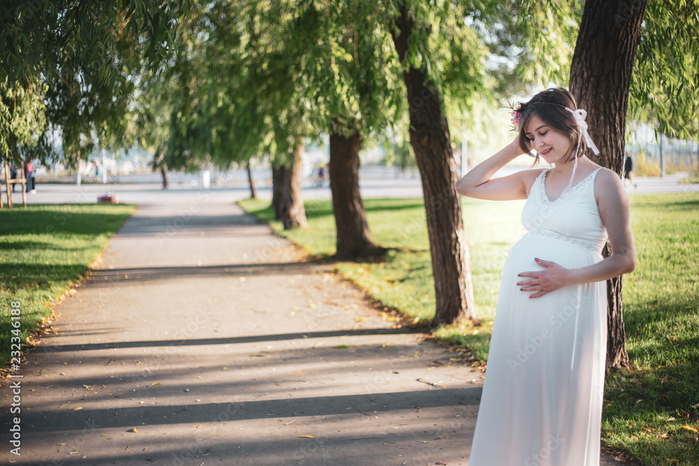Beatiful Pregnant women smiling during the sunset Beatiful Pregnant women smiling during the sunset