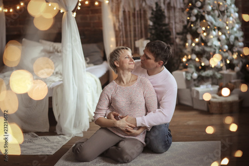 man and a woman are hugging together, Christmas