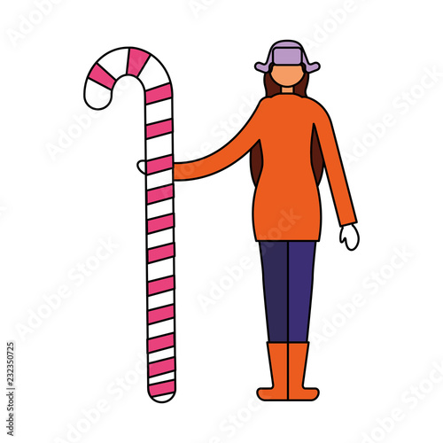 woman in winter clothes holding candy cane