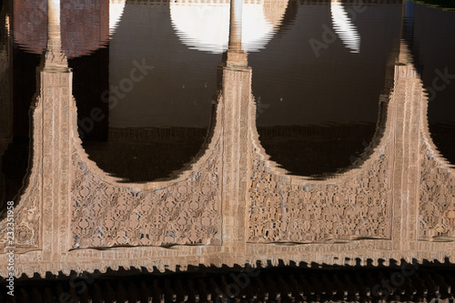 Arabesque arches reflection in the mirror of water. Alhambra of Granada, Spain