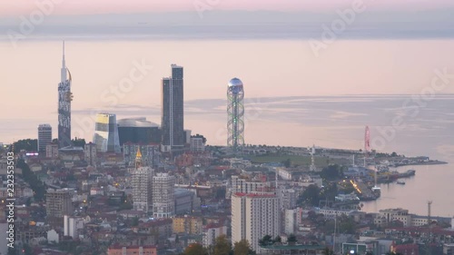 Top view of the evening embankment of Batumi, ferris wheel, tower of the Georgian alphabet. View of the city from the observation deck at the top of the cable car. photo